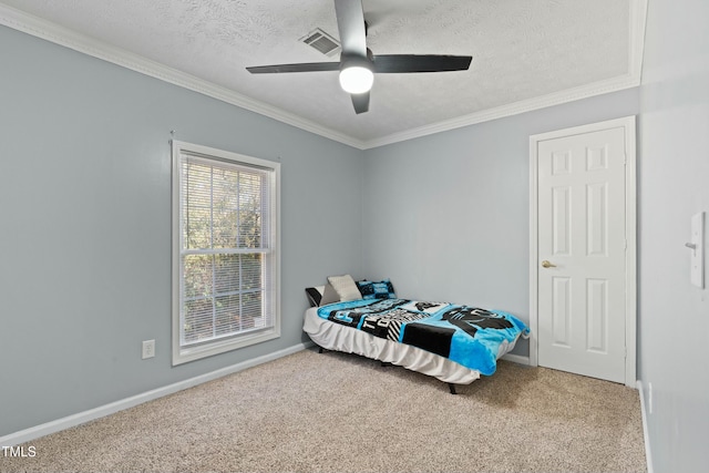 carpeted bedroom with a textured ceiling, ceiling fan, and ornamental molding