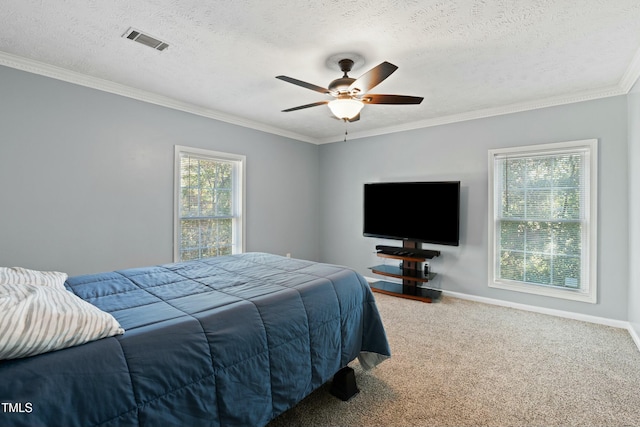 carpeted bedroom with ceiling fan, a textured ceiling, and ornamental molding