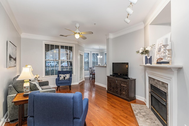 living room featuring crown molding, ceiling fan, and hardwood / wood-style flooring