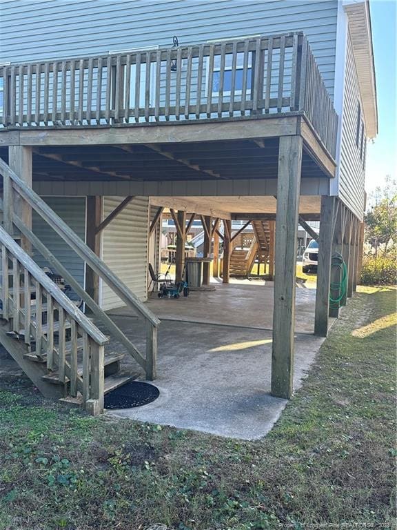 view of patio / terrace featuring a wooden deck and a carport