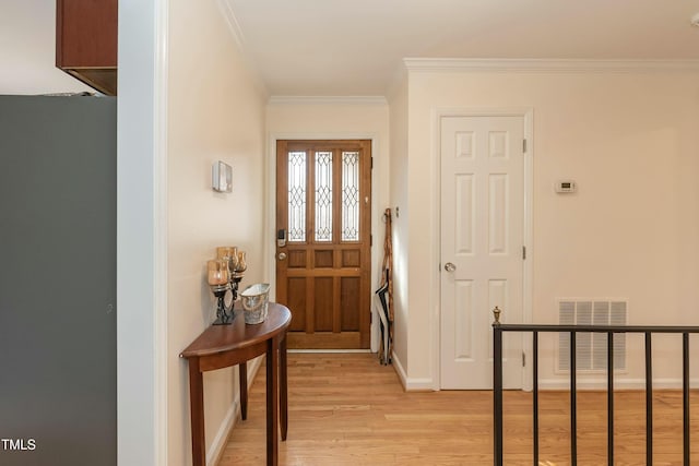 foyer featuring light hardwood / wood-style flooring and ornamental molding