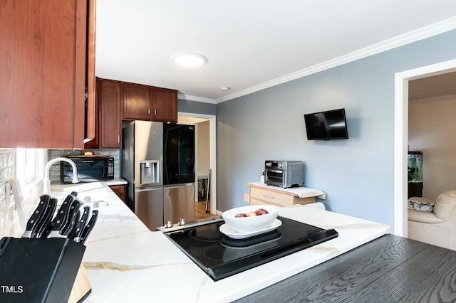 kitchen featuring tasteful backsplash, crown molding, sink, and black appliances