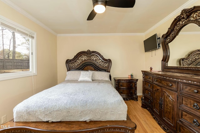 bedroom featuring light wood-type flooring, ceiling fan, and ornamental molding