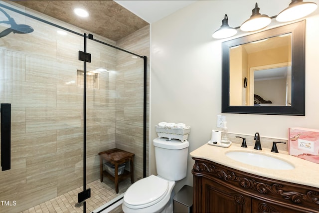 bathroom featuring vanity, toilet, and an enclosed shower