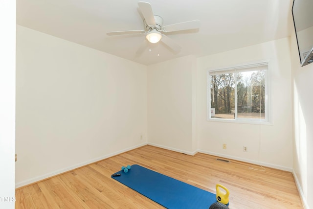 exercise area featuring ceiling fan and hardwood / wood-style floors