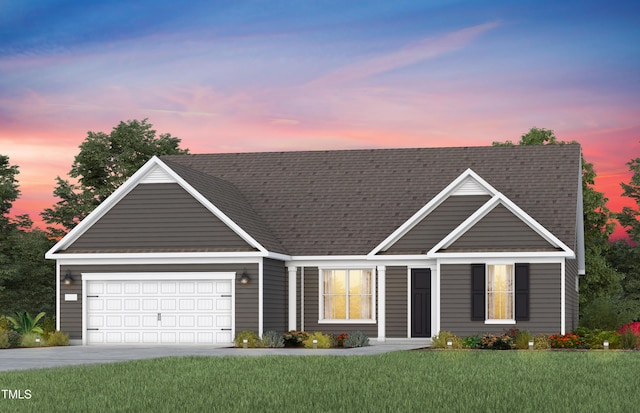 view of front of house featuring a garage, a yard, concrete driveway, and a shingled roof