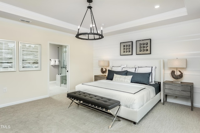 carpeted bedroom featuring a raised ceiling, ensuite bathroom, a chandelier, and ornamental molding