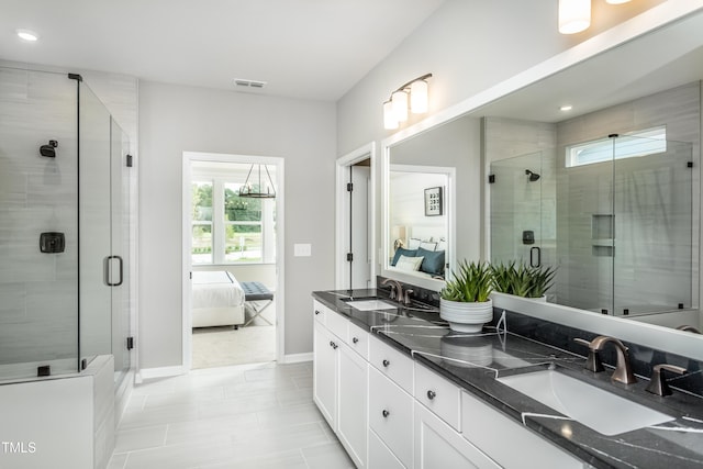 bathroom featuring tile patterned flooring, vanity, and an enclosed shower