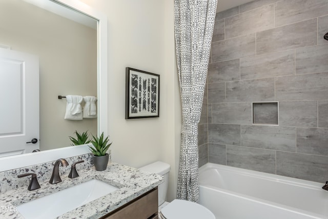 full bathroom featuring vanity, shower / bath combo, and toilet