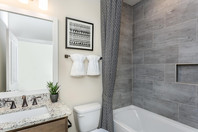 full bathroom with vanity, toilet, and tiled shower / bath