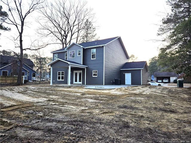 view of front of home with a patio, french doors, board and batten siding, and cooling unit