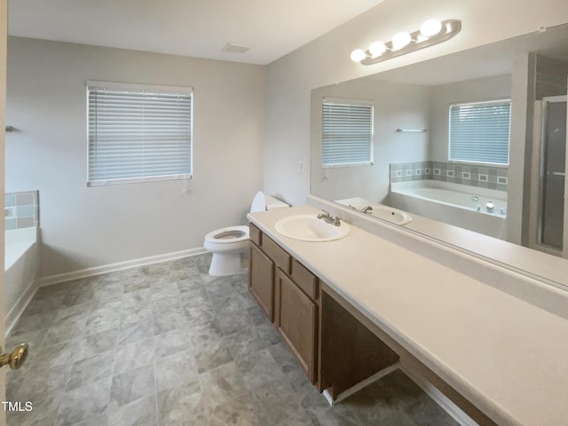 full bathroom featuring vanity, separate shower and tub, and toilet