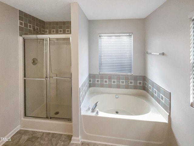 bathroom featuring independent shower and bath