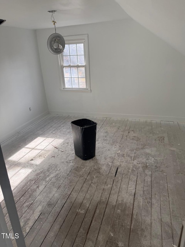 bonus room with wood-type flooring and vaulted ceiling