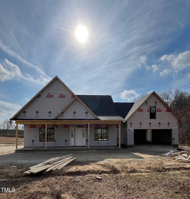 property under construction with a porch and a garage