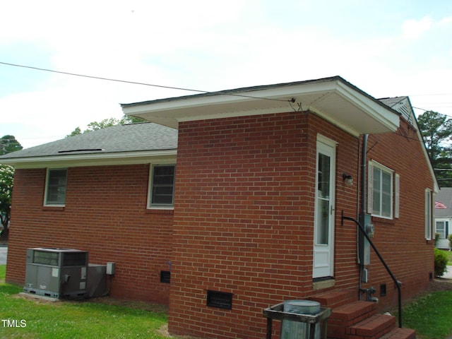 view of home's exterior featuring central AC and a lawn