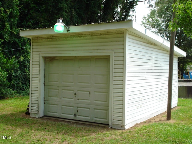 garage featuring a lawn