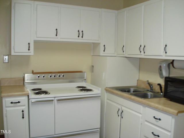 kitchen with white cabinetry, double oven range, and sink