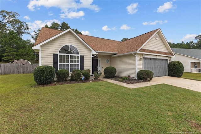 single story home with a garage and a front lawn