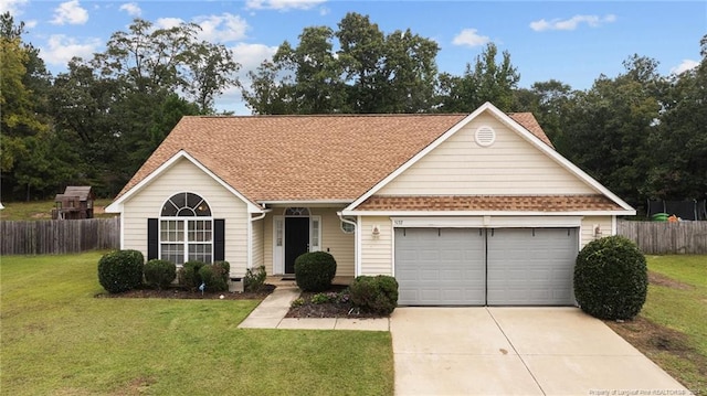 ranch-style house featuring a front yard and a garage