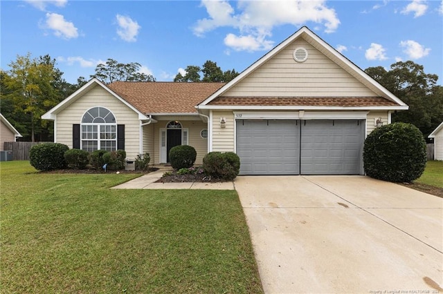 single story home with a garage and a front lawn