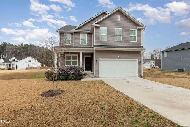 view of front of property with a front yard, a garage, and central AC unit