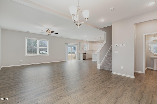 unfurnished living room featuring light hardwood / wood-style floors and ceiling fan with notable chandelier