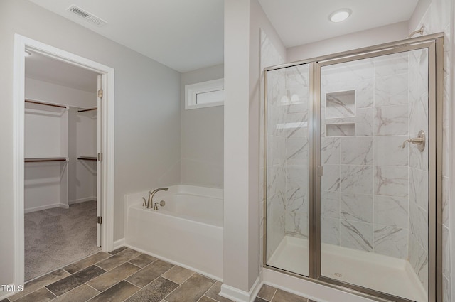 bathroom featuring independent shower and bath