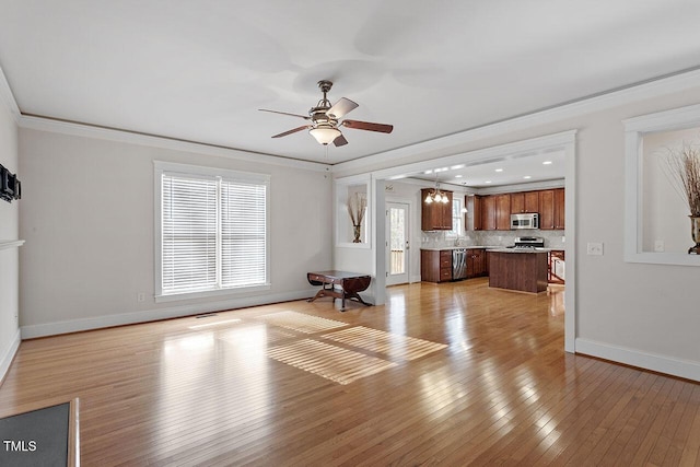 unfurnished living room featuring crown molding, light wood finished floors, recessed lighting, a ceiling fan, and baseboards