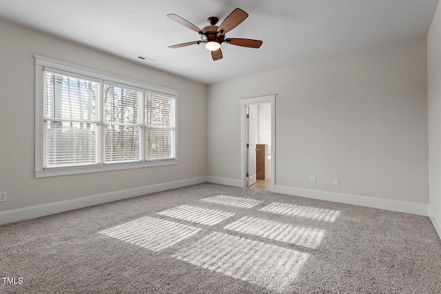 spare room featuring light carpet, baseboards, and visible vents