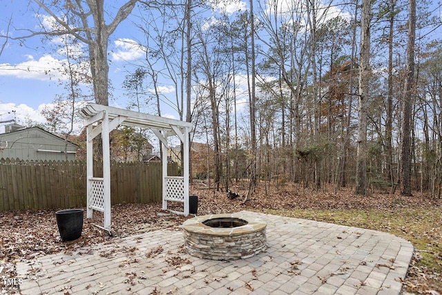 view of patio with a fire pit and fence