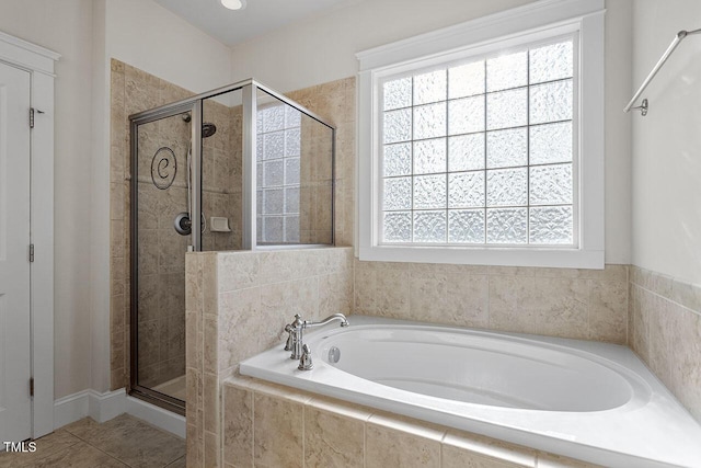 full bath with a bath, tile patterned flooring, a shower stall, and a wealth of natural light