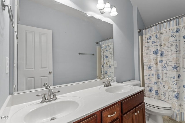 bathroom featuring double vanity, a sink, toilet, and a shower with curtain