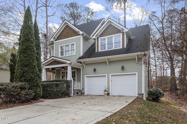 craftsman inspired home with driveway, a shingled roof, and an attached garage