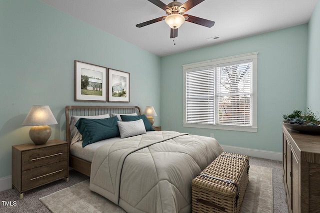 bedroom with carpet floors, visible vents, ceiling fan, and baseboards