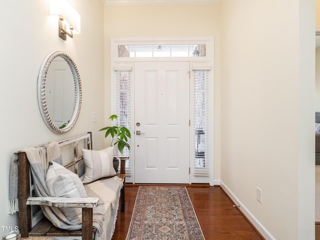 foyer entrance with dark hardwood / wood-style floors and crown molding