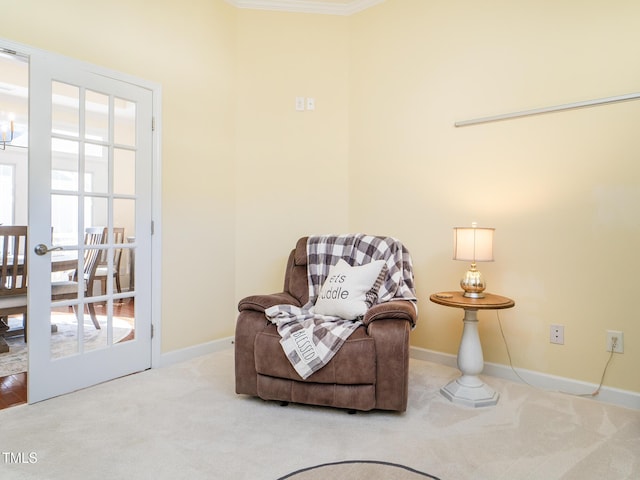 sitting room featuring plenty of natural light, carpet floors, and ornamental molding