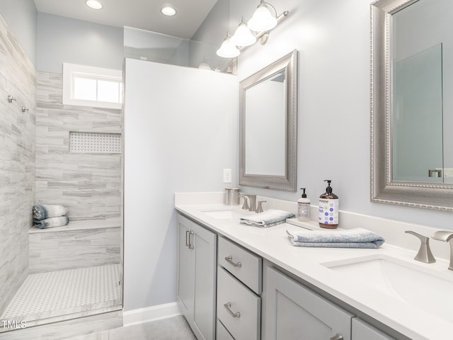 bathroom with vanity and tiled shower