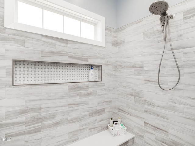 bathroom with a tile shower