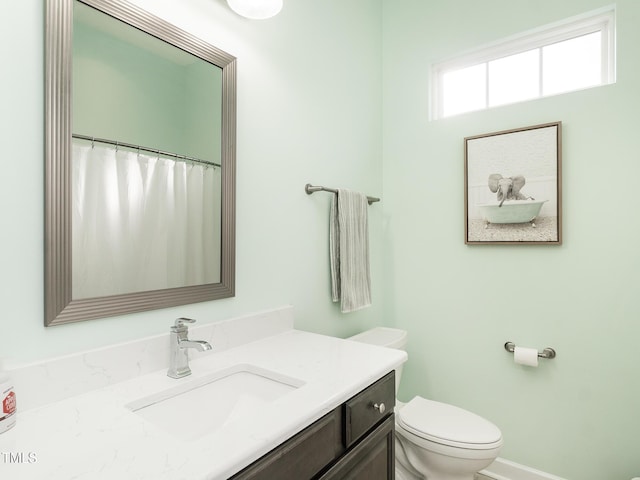 bathroom featuring vanity and toilet