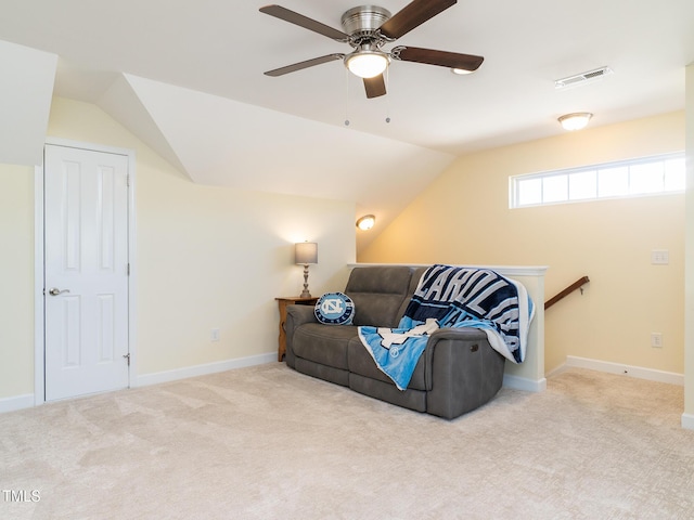 carpeted living room featuring ceiling fan and vaulted ceiling