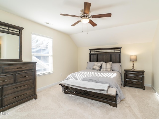 bedroom with ceiling fan, light colored carpet, and vaulted ceiling