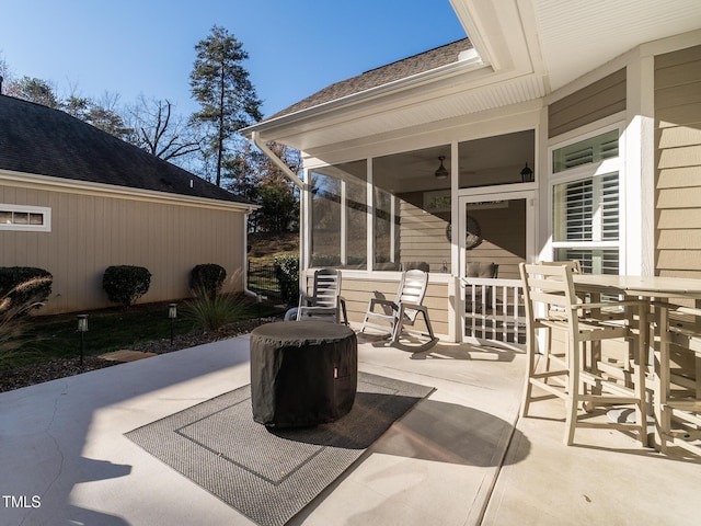 view of patio featuring a sunroom