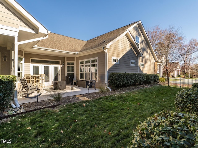 back of property featuring a lawn and a patio area