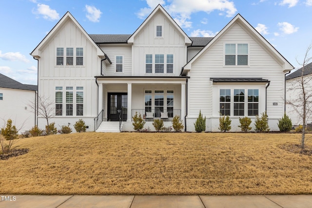 view of front of house with covered porch and a front yard