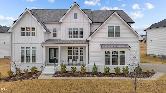 view of front of house featuring central AC unit, covered porch, and a front lawn