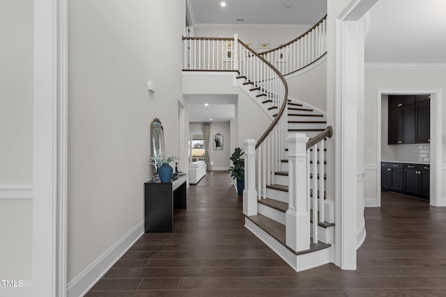 entryway with dark hardwood / wood-style floors and crown molding