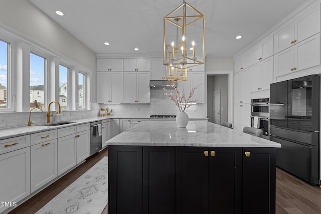 kitchen with white cabinets, a center island, dark wood-type flooring, and stainless steel appliances