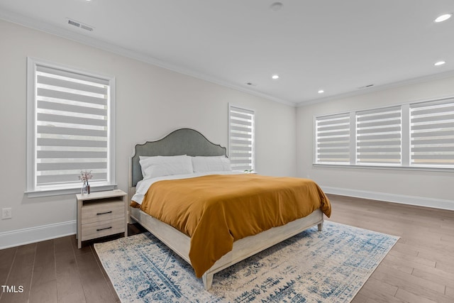 bedroom with light wood-type flooring and ornamental molding