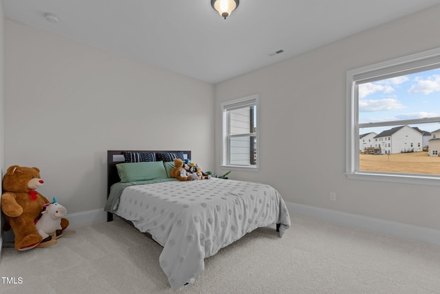 carpeted bedroom with multiple windows